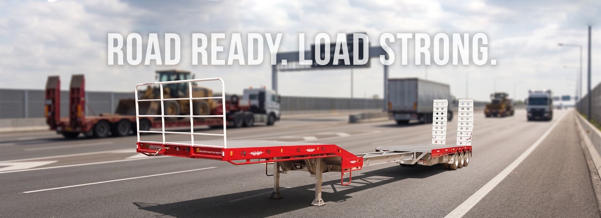 Freightmore drop-deck trailer on the highway — Road ready. Load strong.